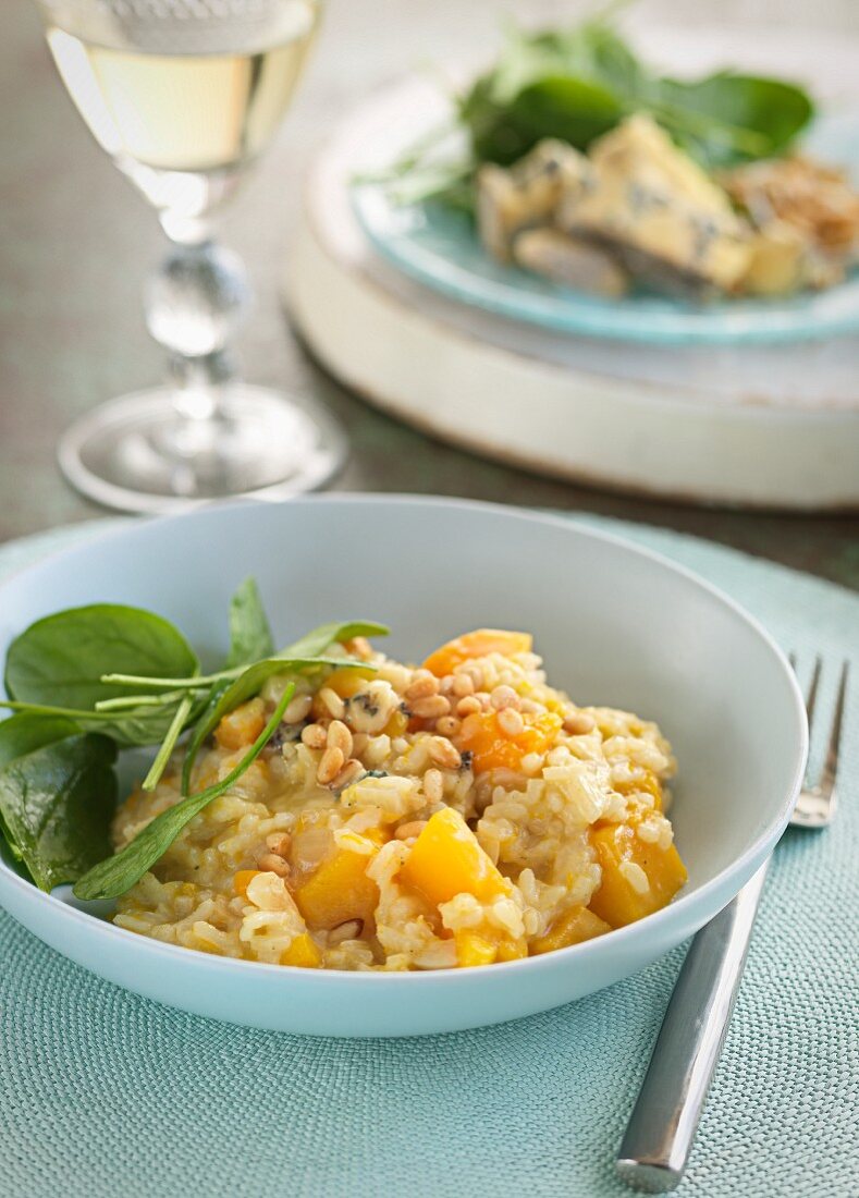 Pumpkin risotto with pine nuts and baby spinach