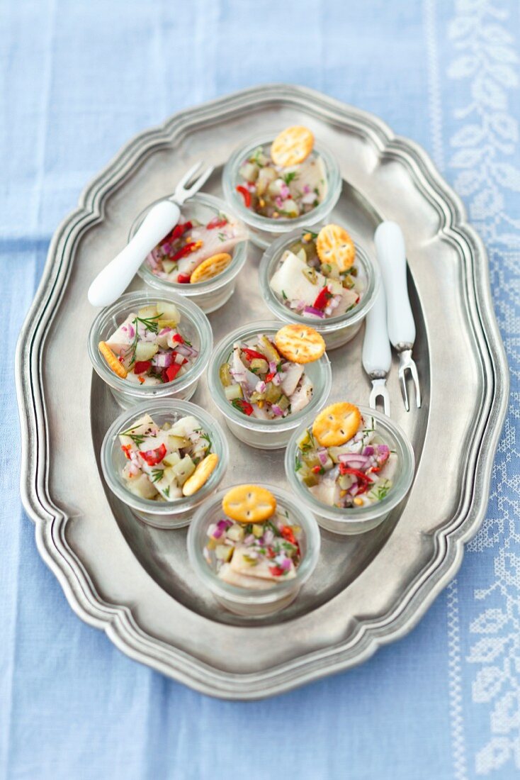 Herring salad with gherkins, chilli, onions and dill served with crackers