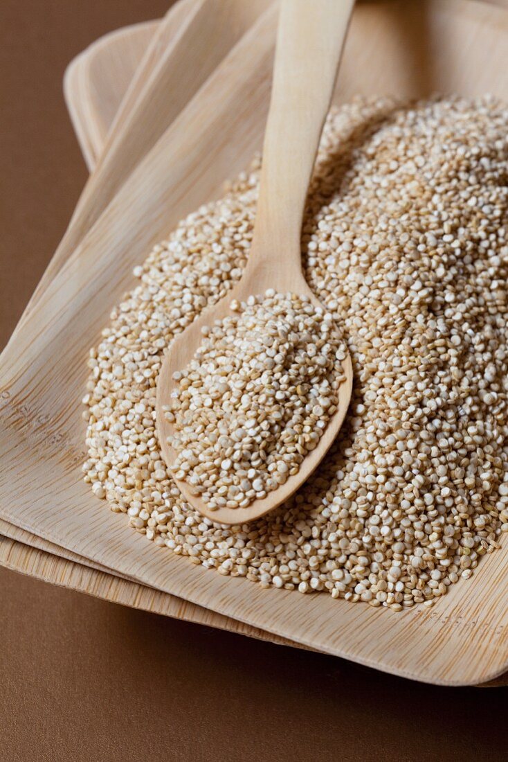 Quinoa in a wooden bowl with a spoon