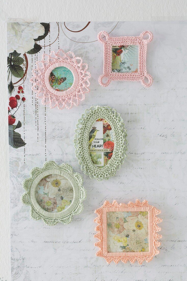 Pictures in crocheted frames hung on wall