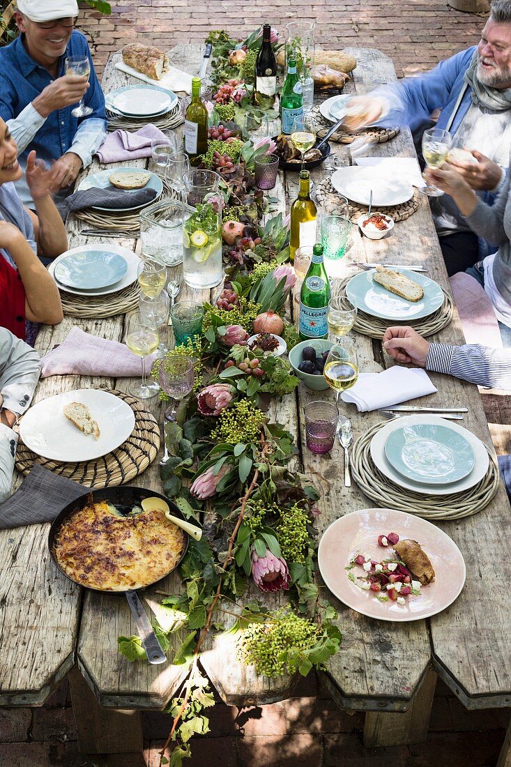 Crispy duck and potato and mozzarella gratin on rustically set table