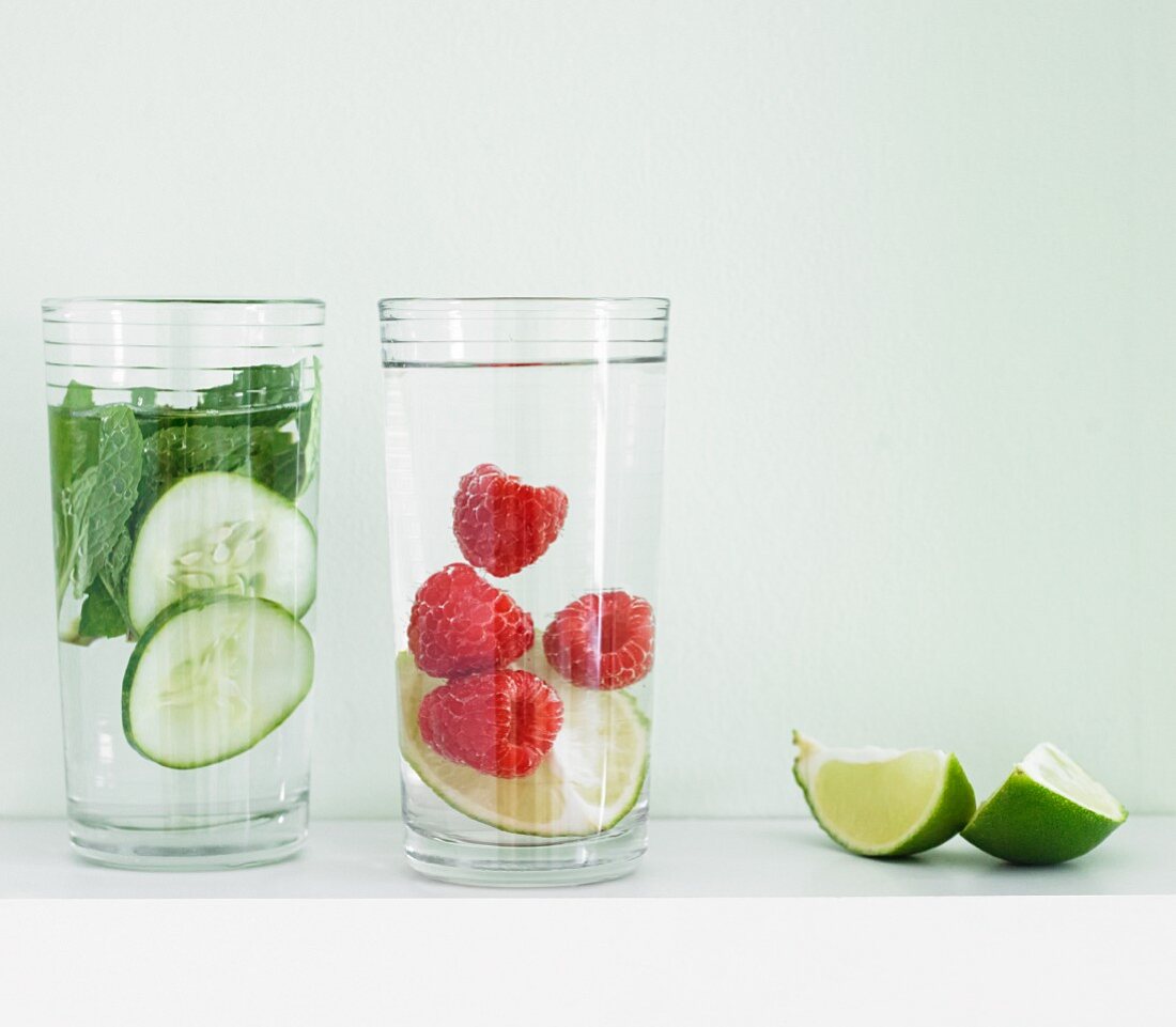 Flavoured water (cucumber-mint, and raspberry-lime) with lime wedges