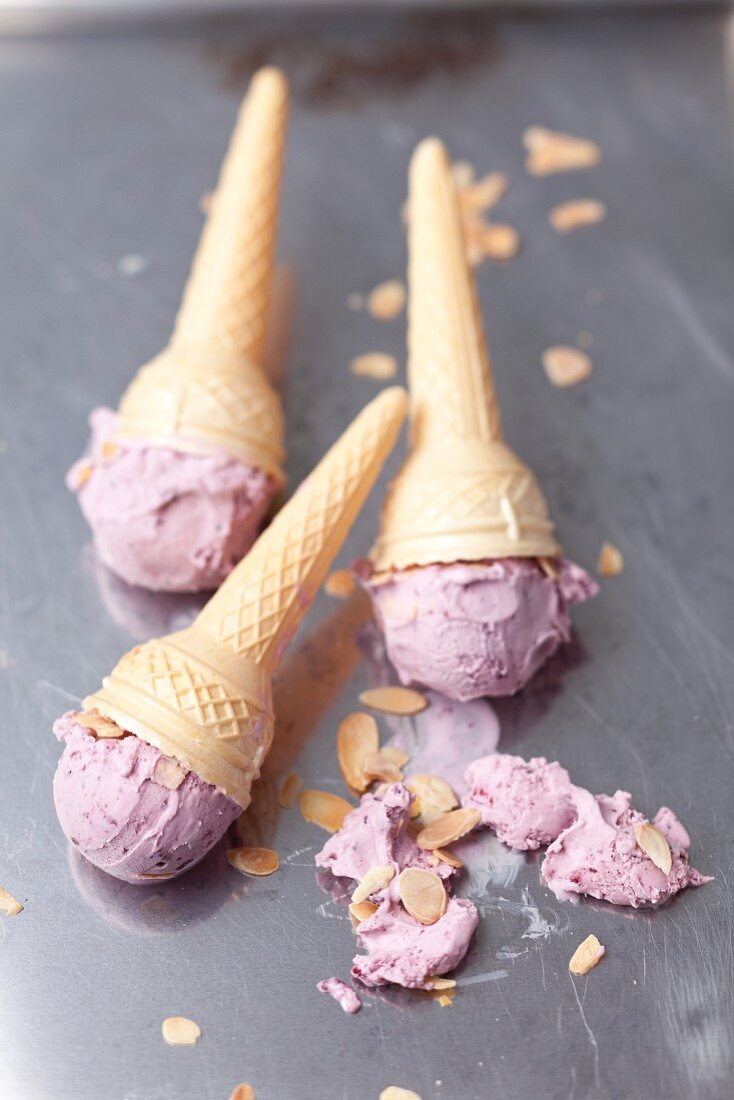 Blueberry ice cream with flaked almonds in cones