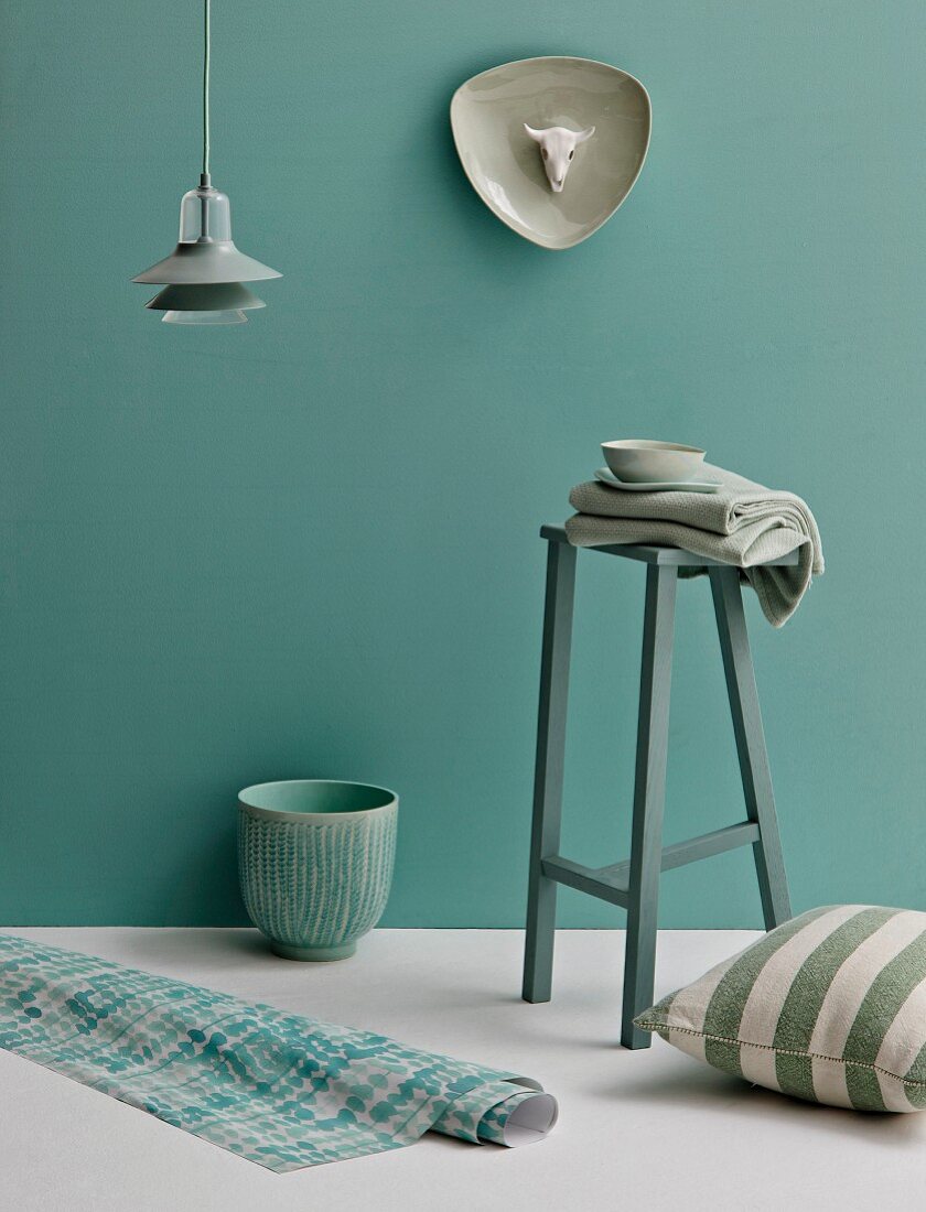 Stool, pendant lamp, ornaments and home textiles in shades of pastel green