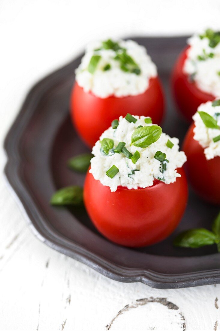 Tomatoes stuffed with cottage cheese, fresh chives and basil