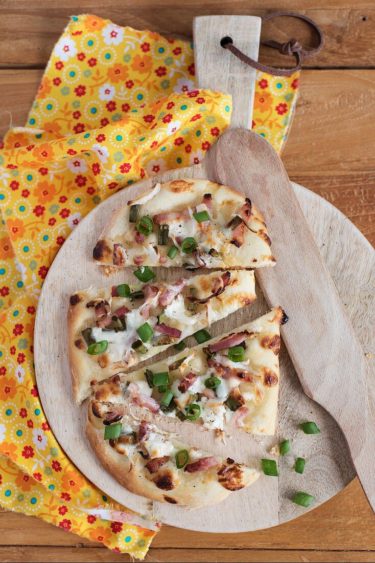 Tarte flambée topped with bacon and onions