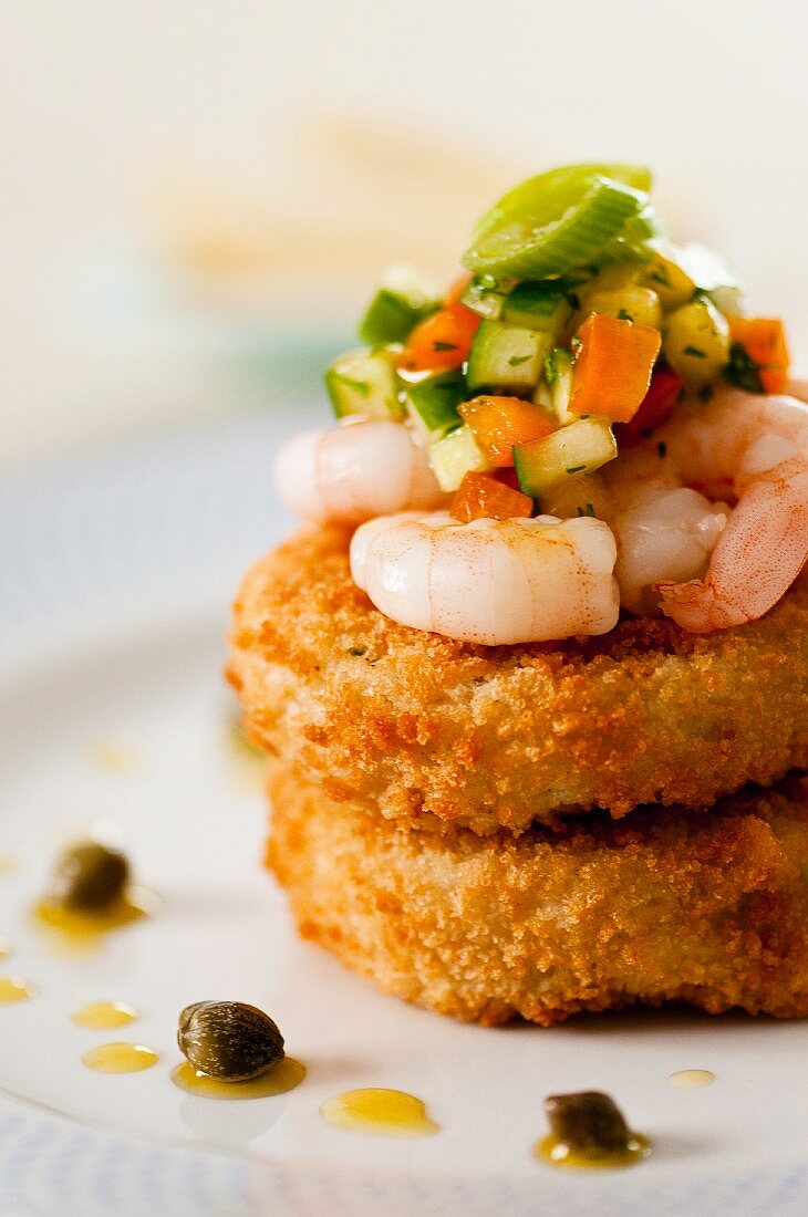 Fish cakes with prawns, vegetable salsa and capers