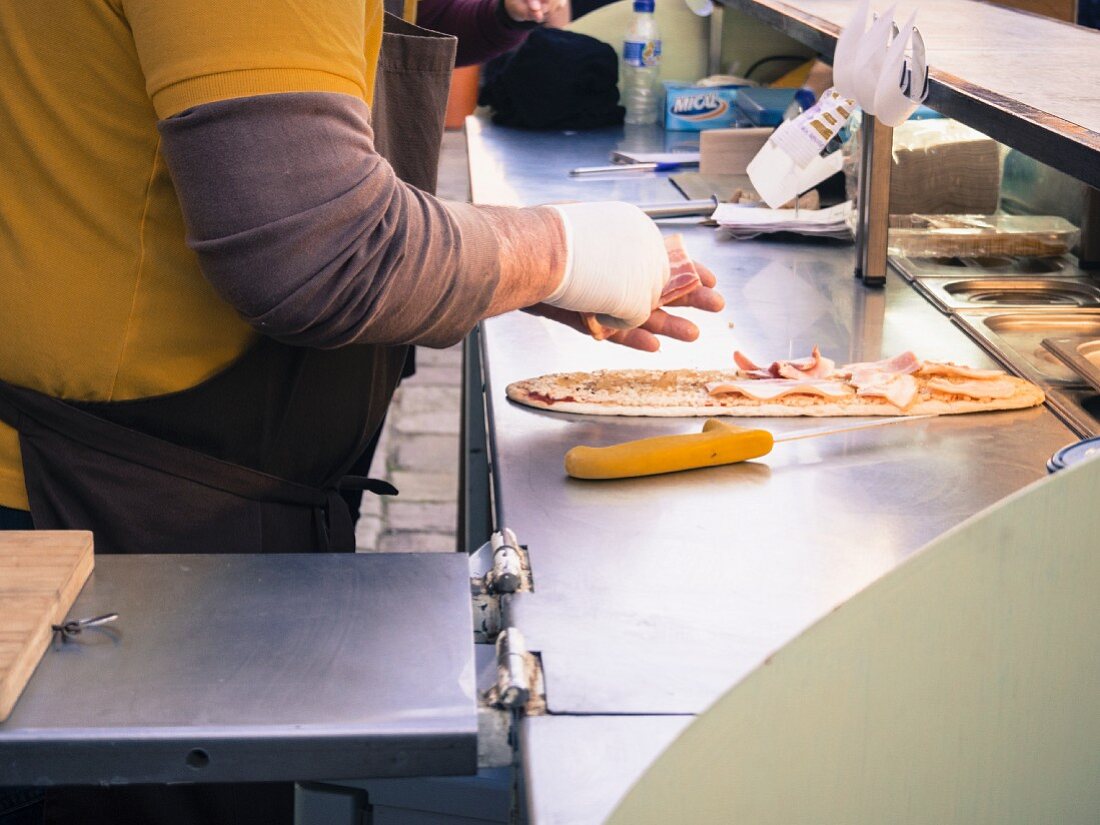 Street food – toppings being added to unleavened bread