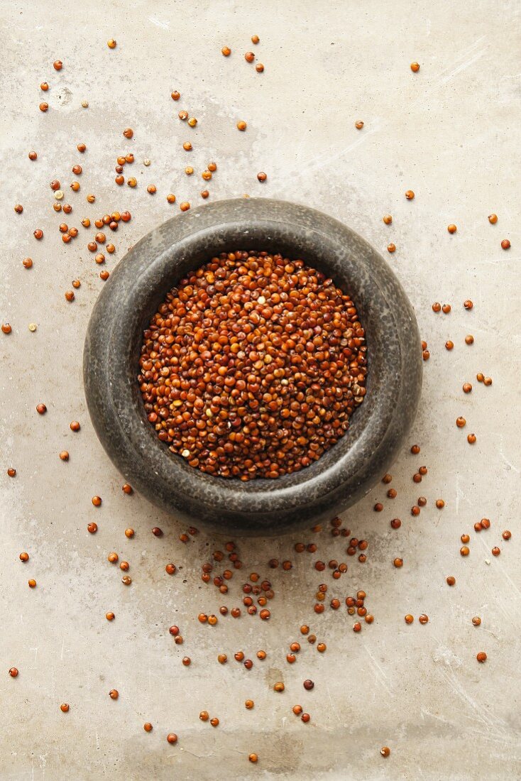 Red quinoa in a stone bowl