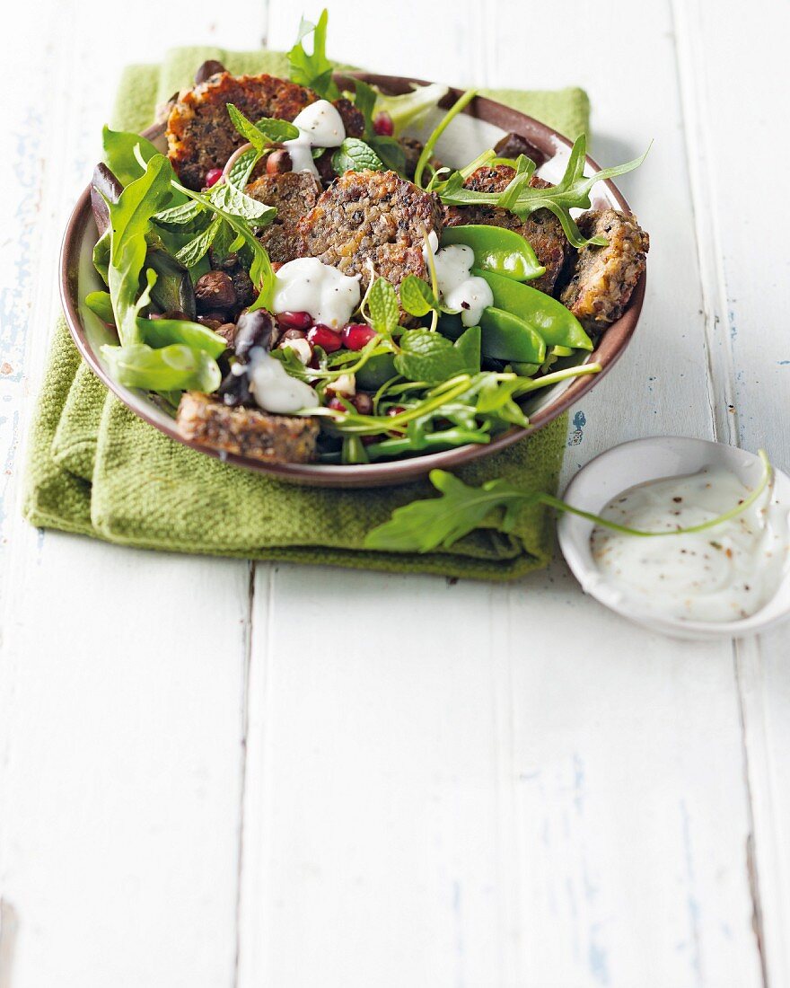 Bean fritters on a bed of salad with yoghurt dressing