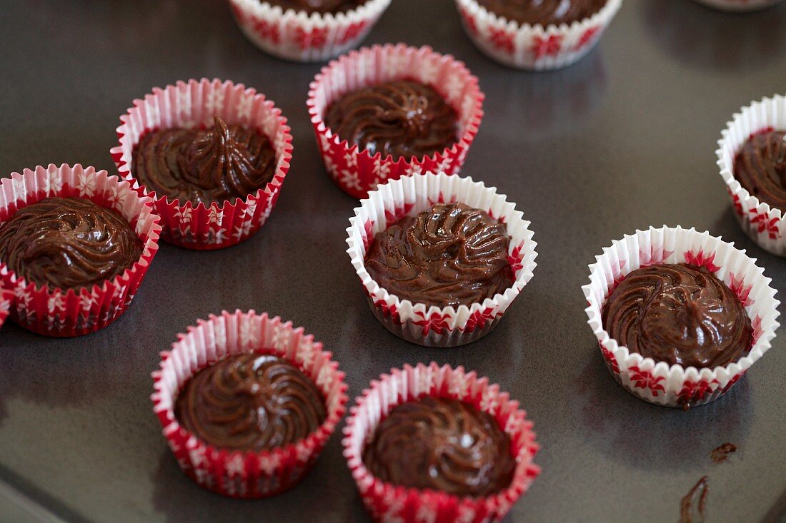 Chocolate muffin mixture in mini paper cases