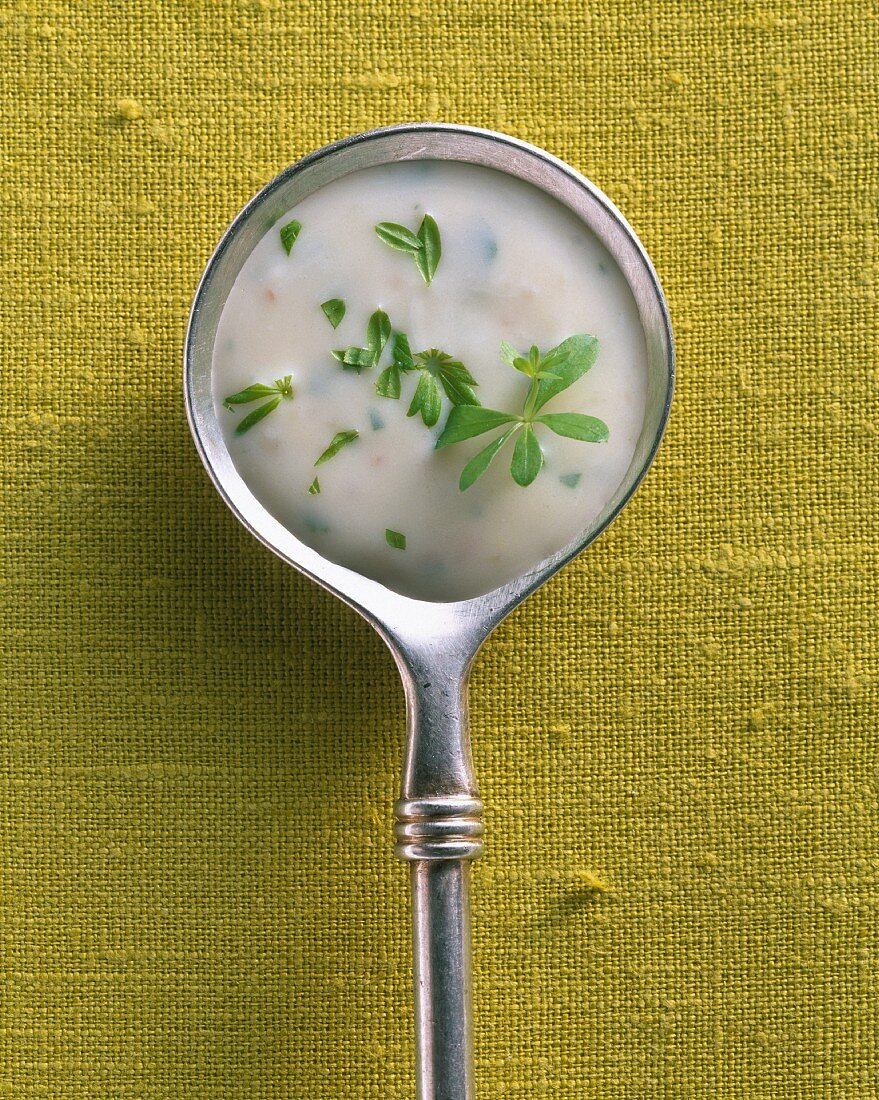 Woodruff and cream sauce on a silver spoon