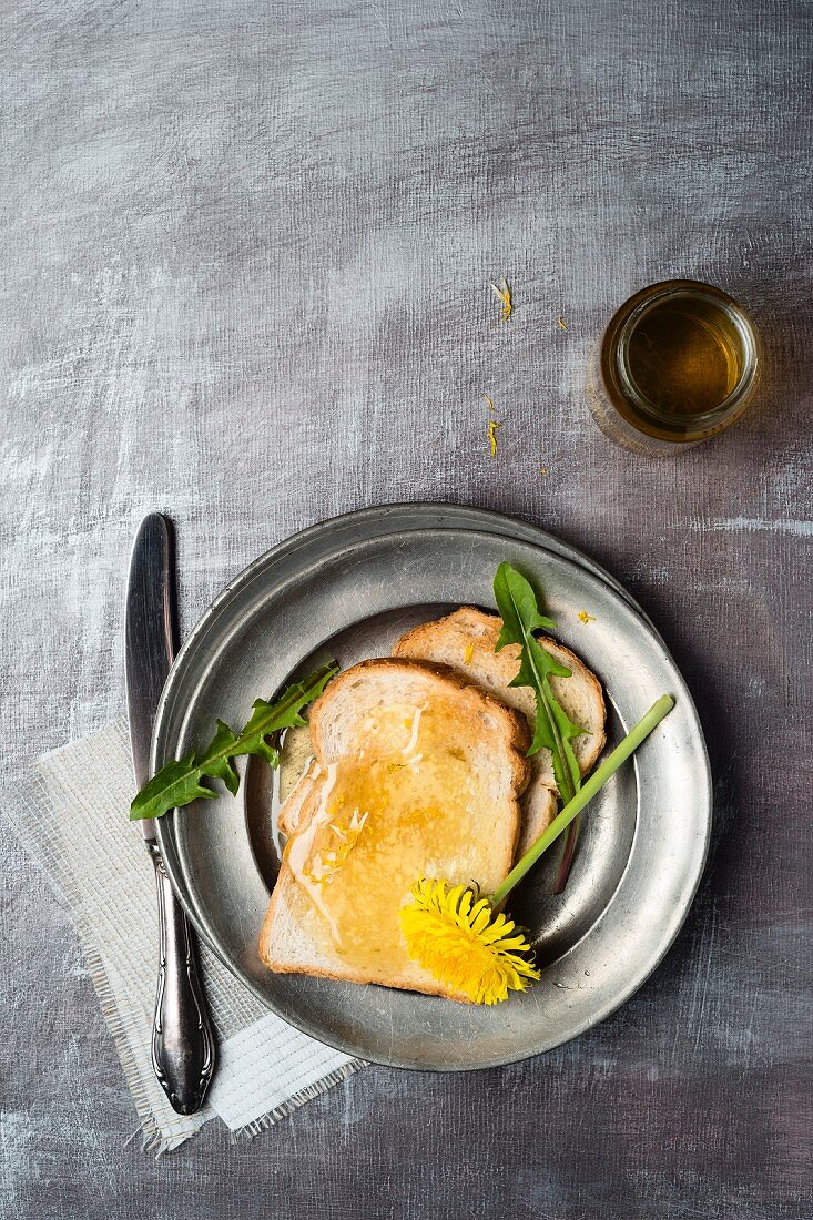 A slice of toast spread with dandelion honey