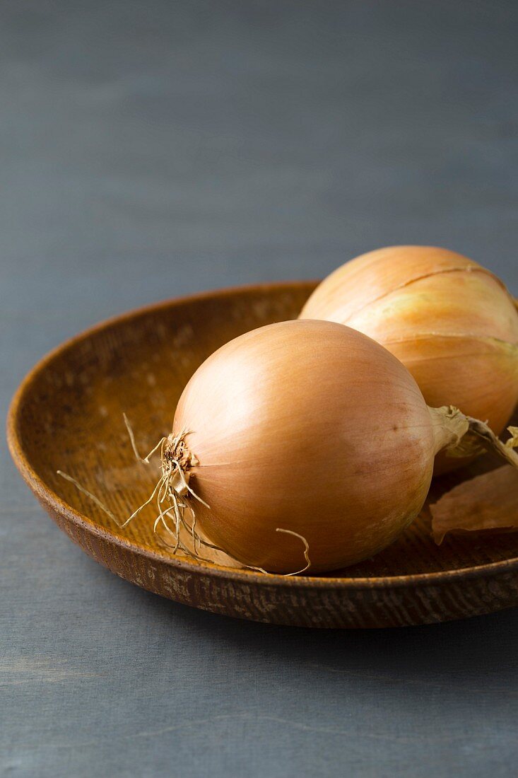 Onions on a wooden plate