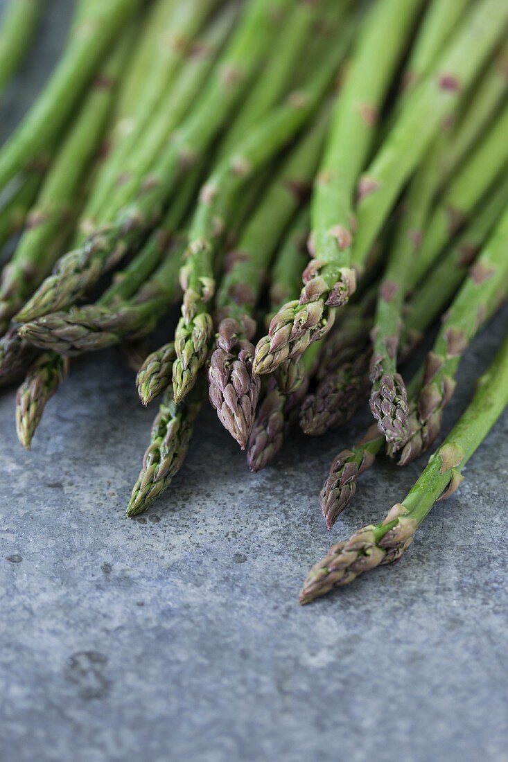 Fresh green asparagus on a metal surface