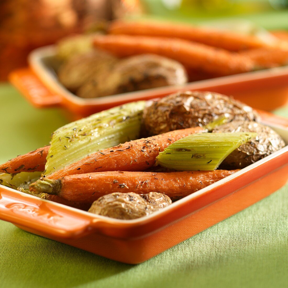 Roast vegetables with carrots, potatoes, celery in olive oil, herbs and salt