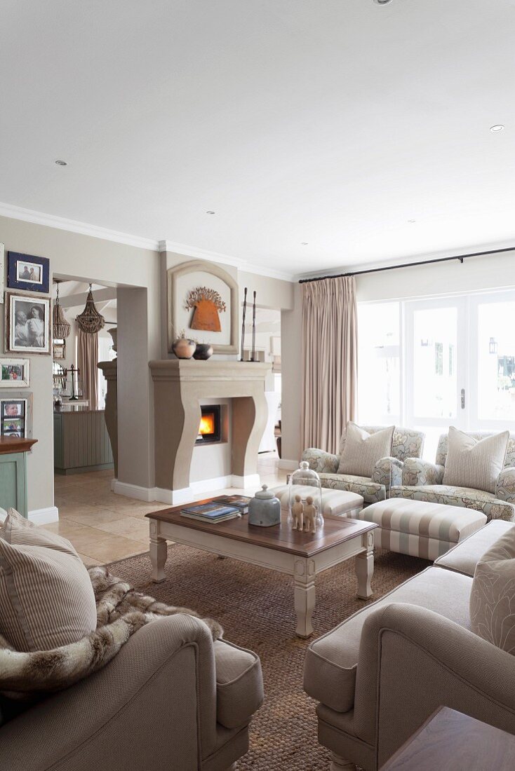 Sofa set around coffee table and fireplace in rustic interior