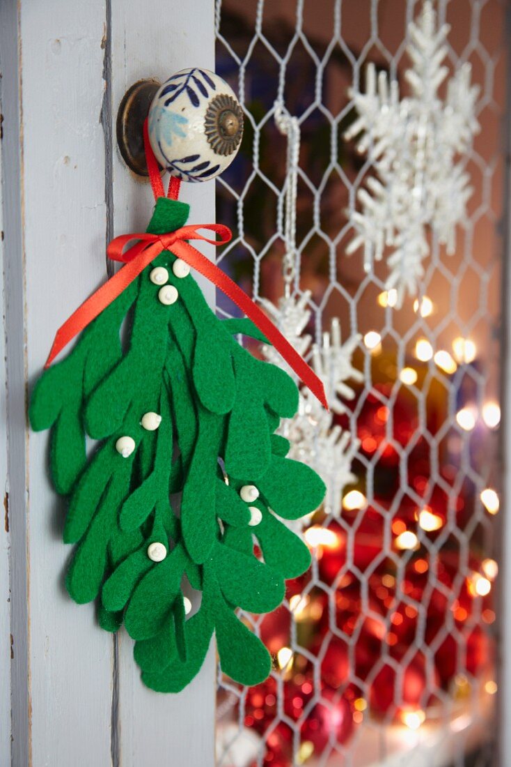 Bunch of felt mistletoe hanging from doorknob