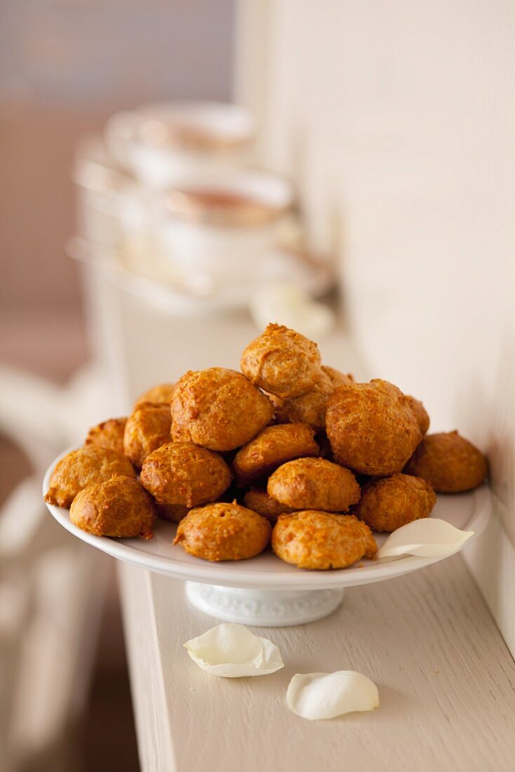 Cheesy bites on a white cake stand
