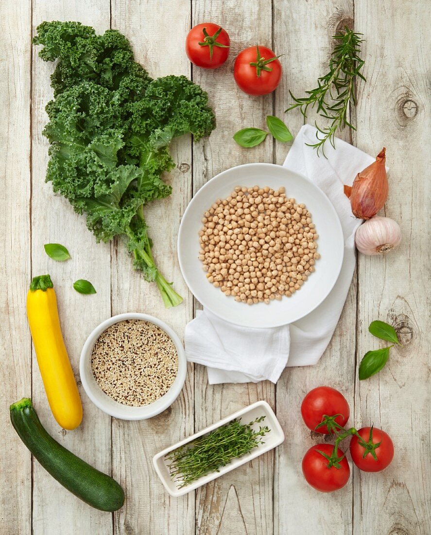 Ingredients for vegan minestrone: kale, quinoa, tomatoes, courgette and chickpeas