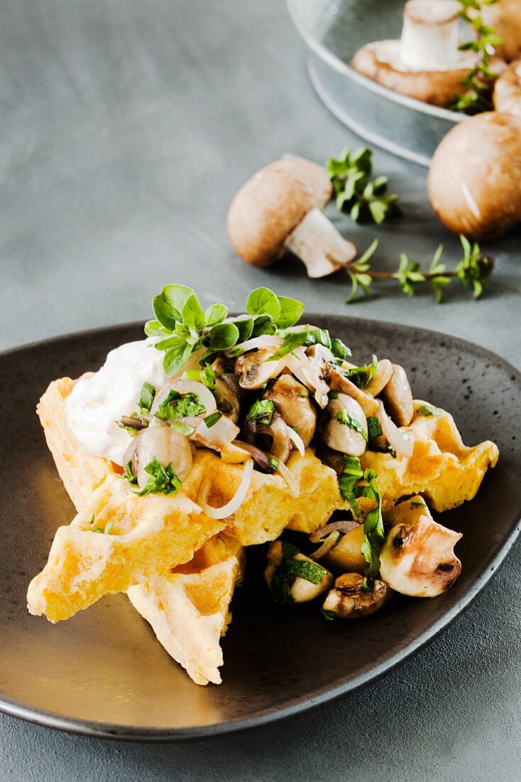 A carrot waffle topped with herb mushrooms