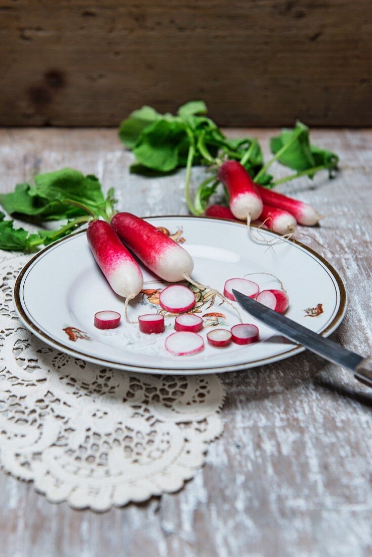 Radishes, partially sliced, on a plate