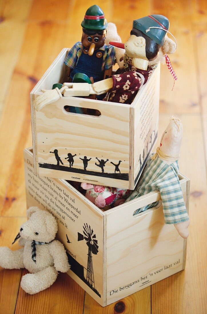 Wooden puppets and hand puppets in wooden crates