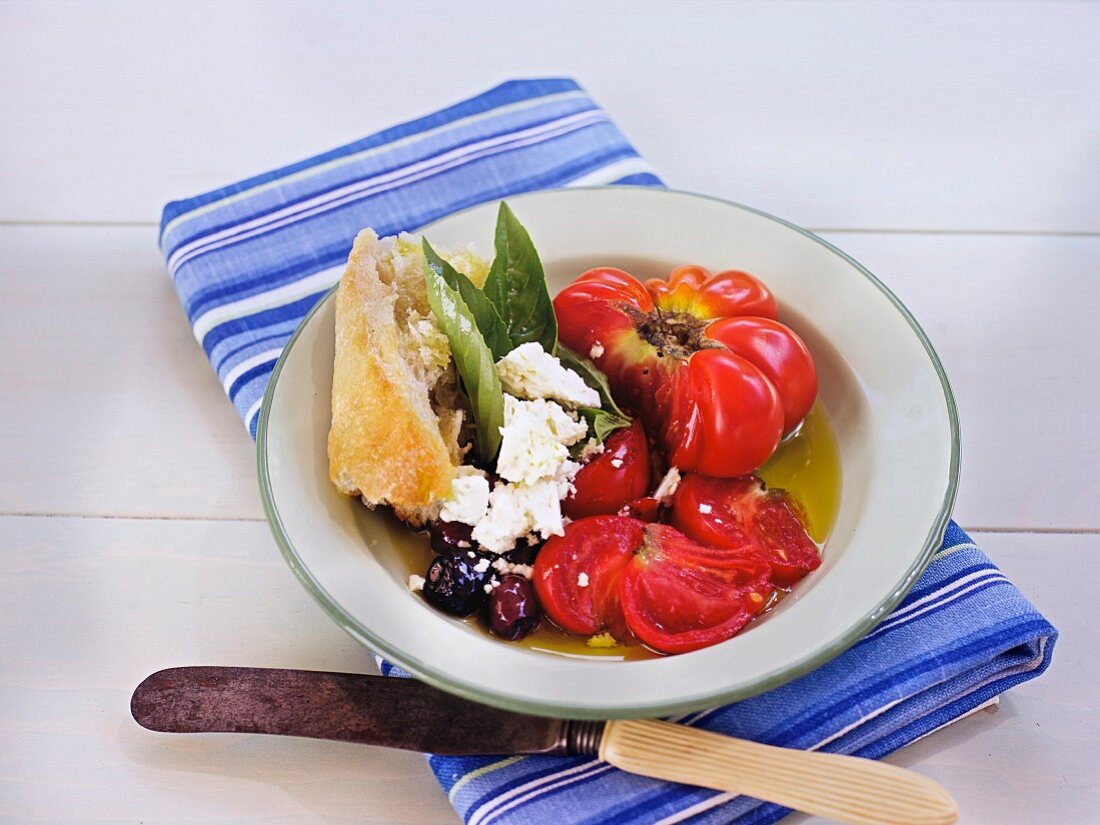 Salad with heirloom tomatoes, olives, bread and feta cheese