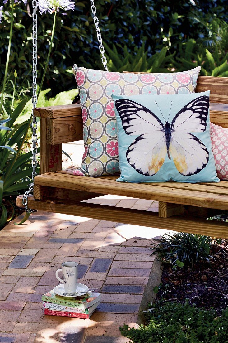 Decorative scatter cushions on DIY swing bench