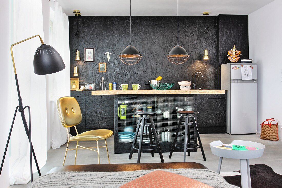 Island counter with chipboard worksurface and bar stools in industrial-style, fitted kitchen