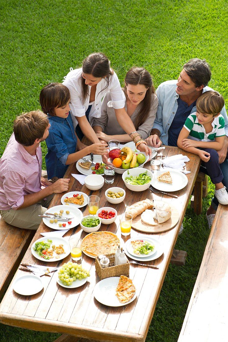 A family eating lunch in a garden