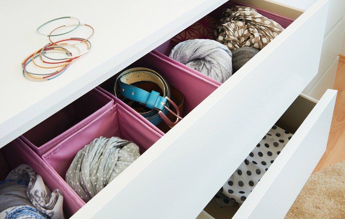 Pink boxes in an open drawer for accessories