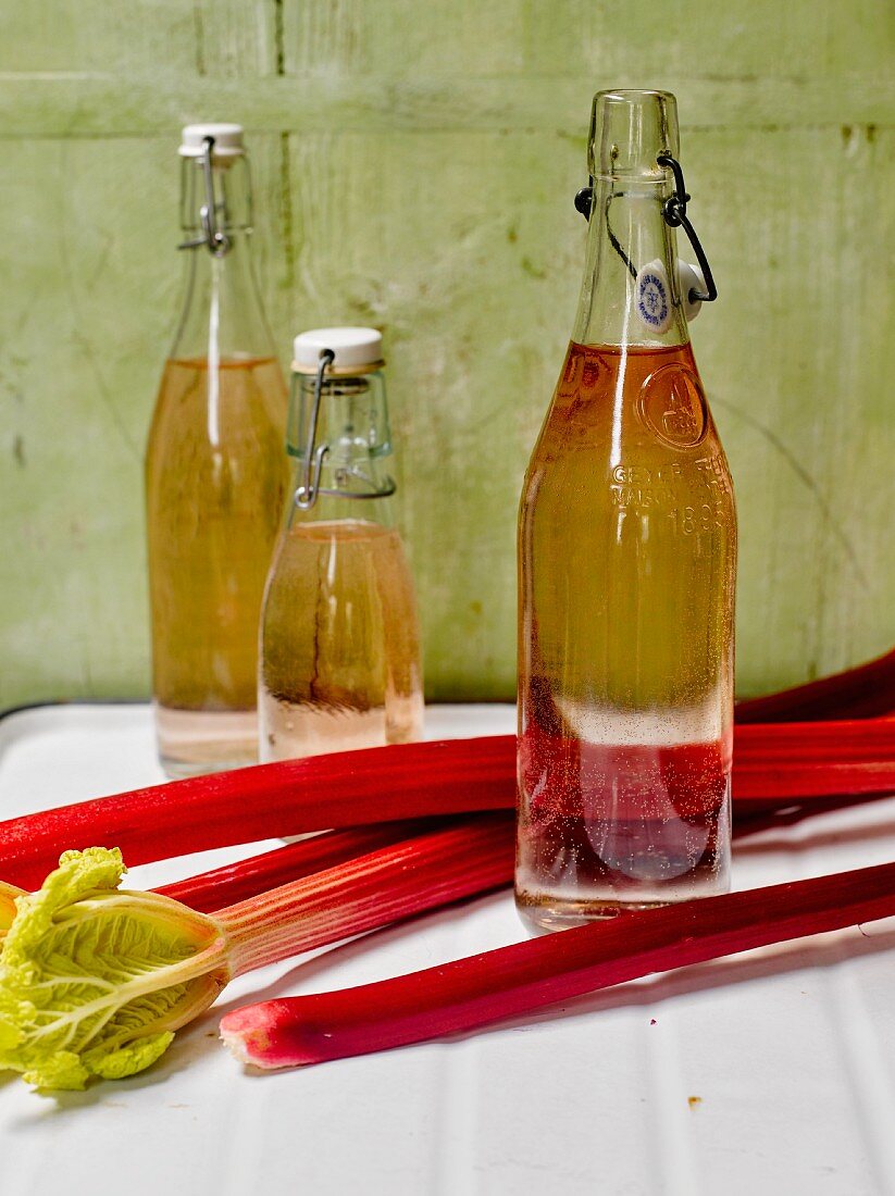 Homemade rhubarb syrup in flip-top bottles