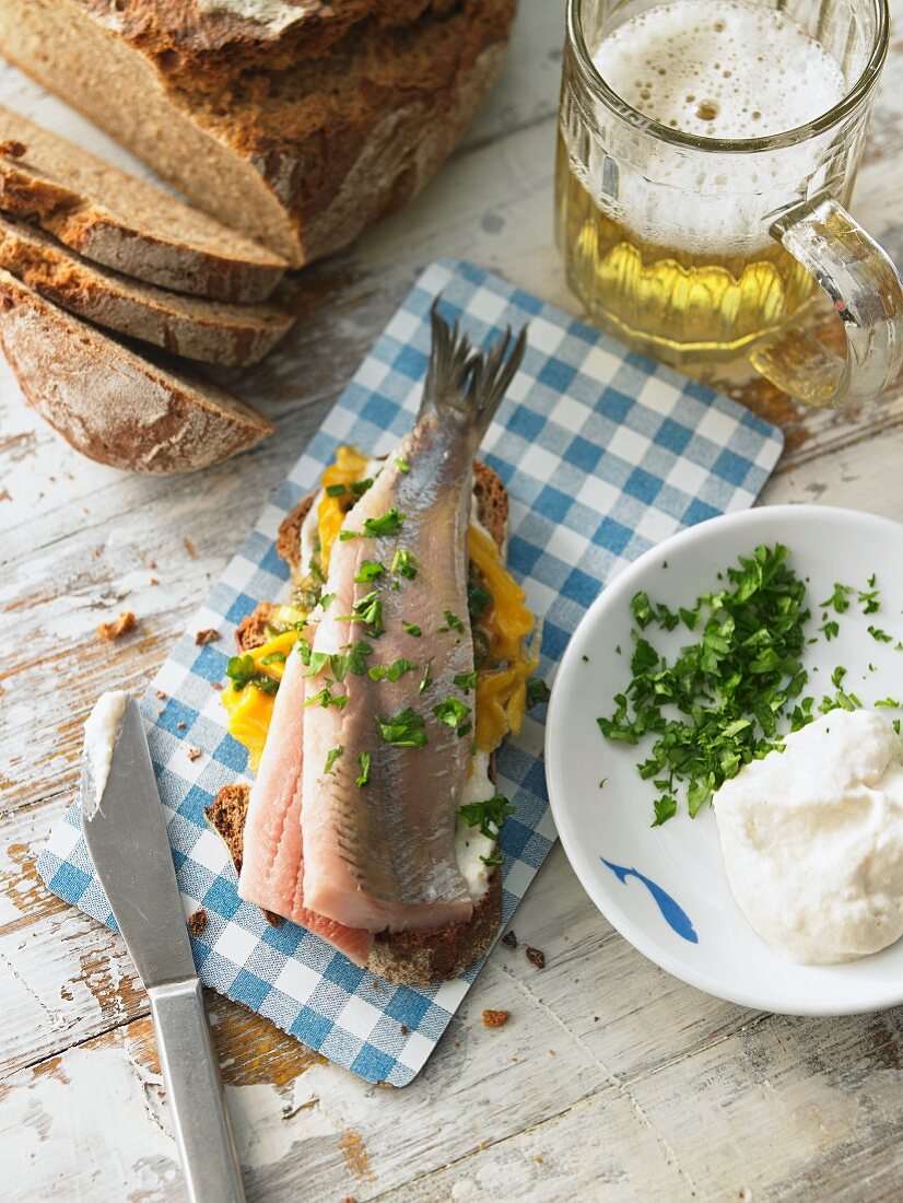 A slice of bread topped with egg, soused herring and horseradish (Northern Germany)