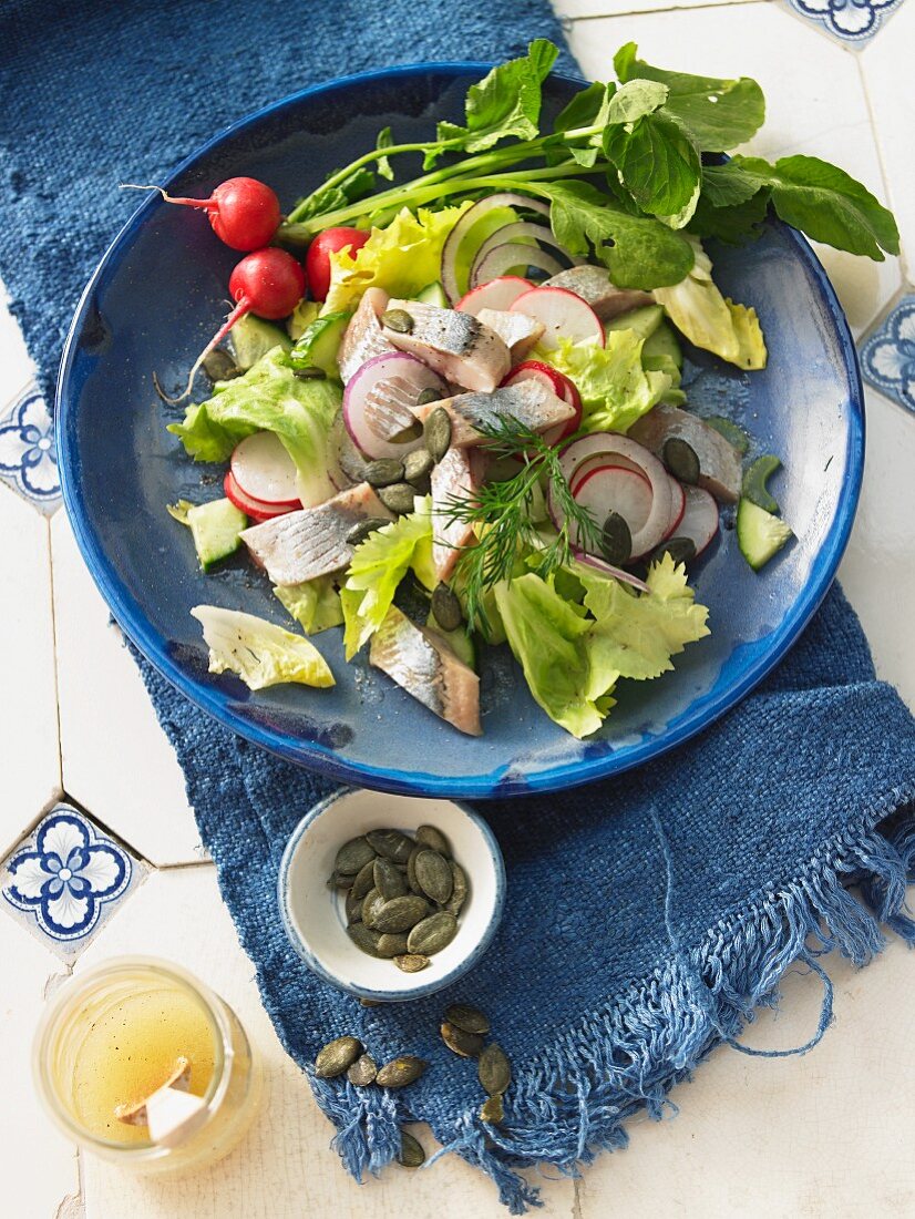 Soused herring with radishes and pumpkin seeds