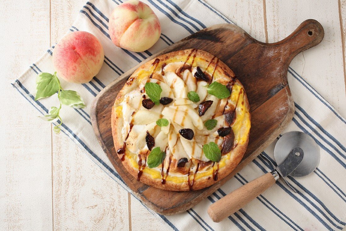 A pizza with peaches and figs