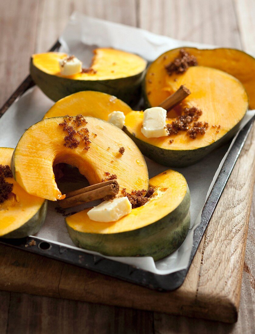 Oven-roasted pumpkin wedges with butter, sugar and cinnamon