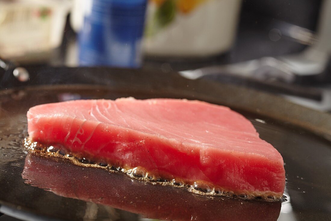 Tuna steak searing on a comal (a Latin American flat grill)