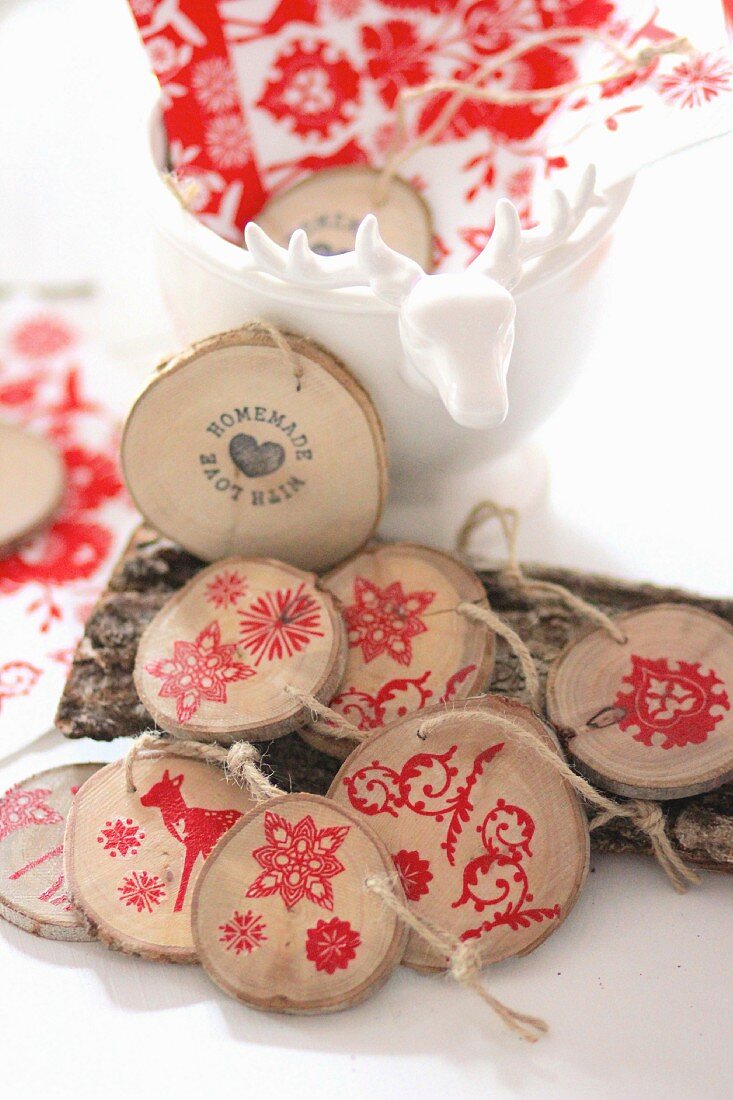 Garland of wooden discs stamped with red festive motifs