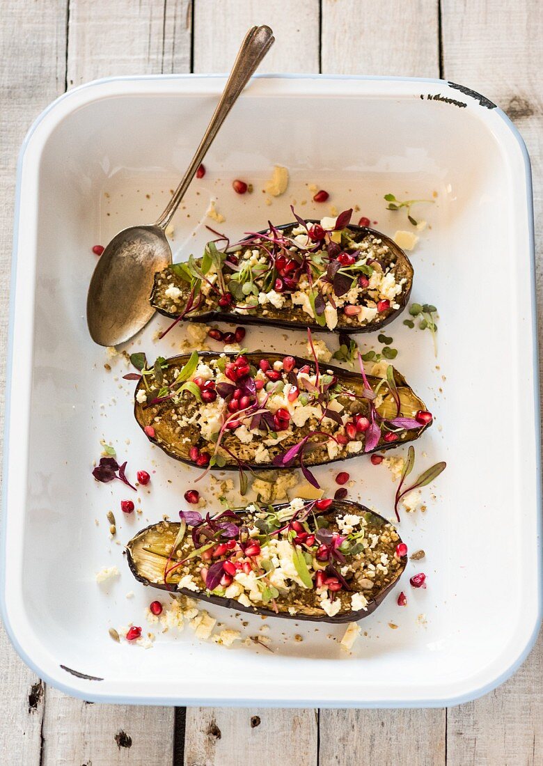 Stuffed aubergines with feta cheese and pomegranate seeds