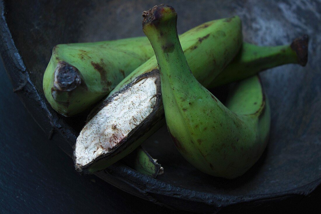 An arrangement of three plantains in a handmade, Africa bowl