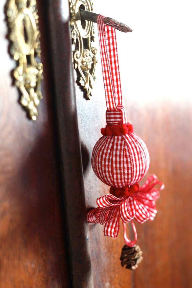 Christmas decorations made from polystyrene balls covered in ribbons, pompoms & pine cones