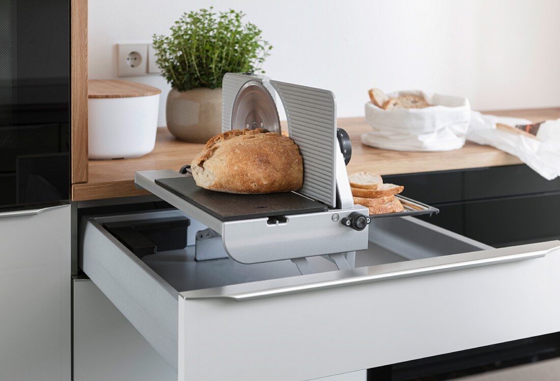 A bread slicer built into a kitchen drawer