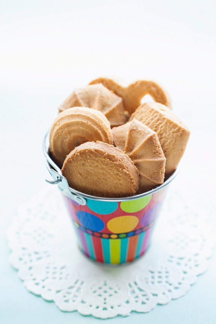 Various biscuits in a colourful bucket
