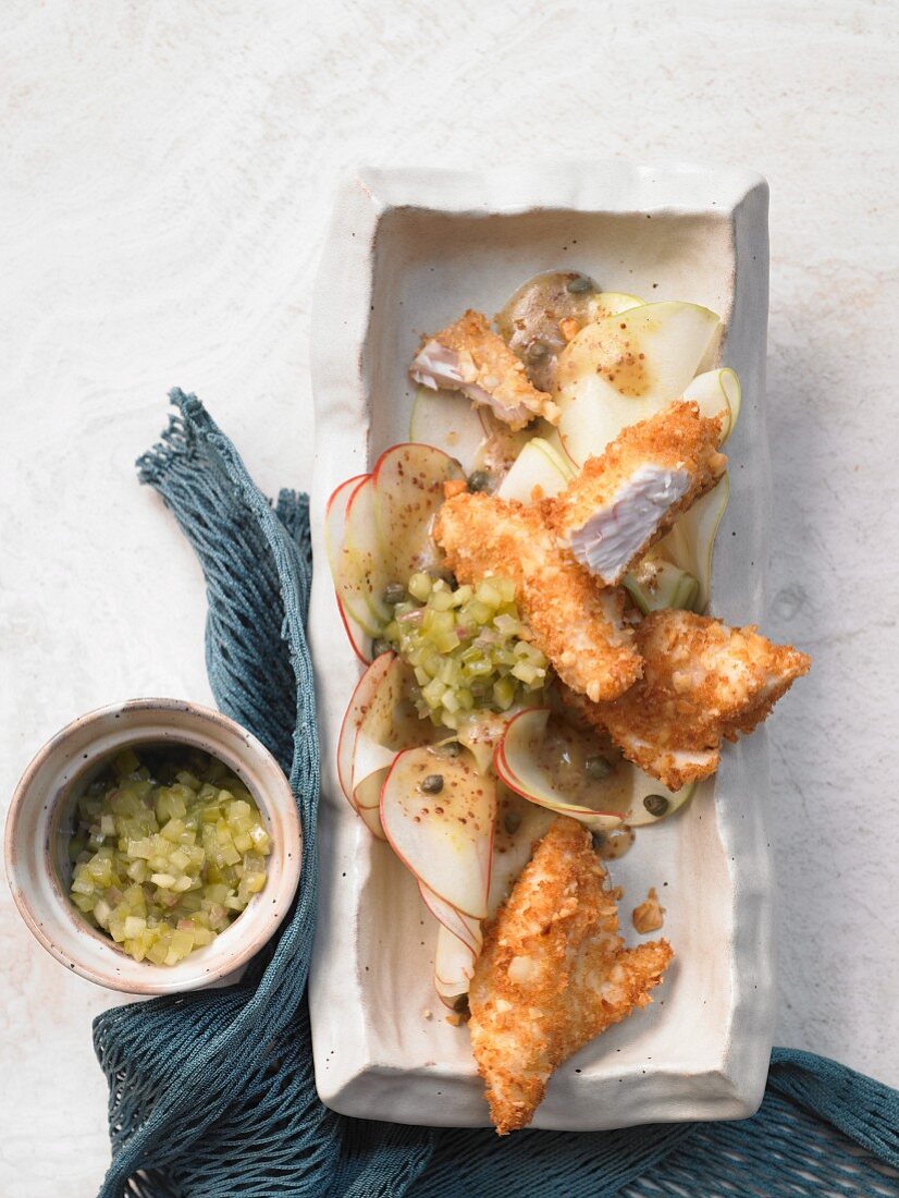 Snapper nuggets with a macadamia nut crust on apple carpaccio with cucumber relish