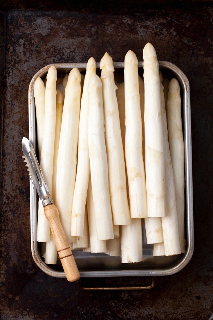 White asparagus with a peeler
