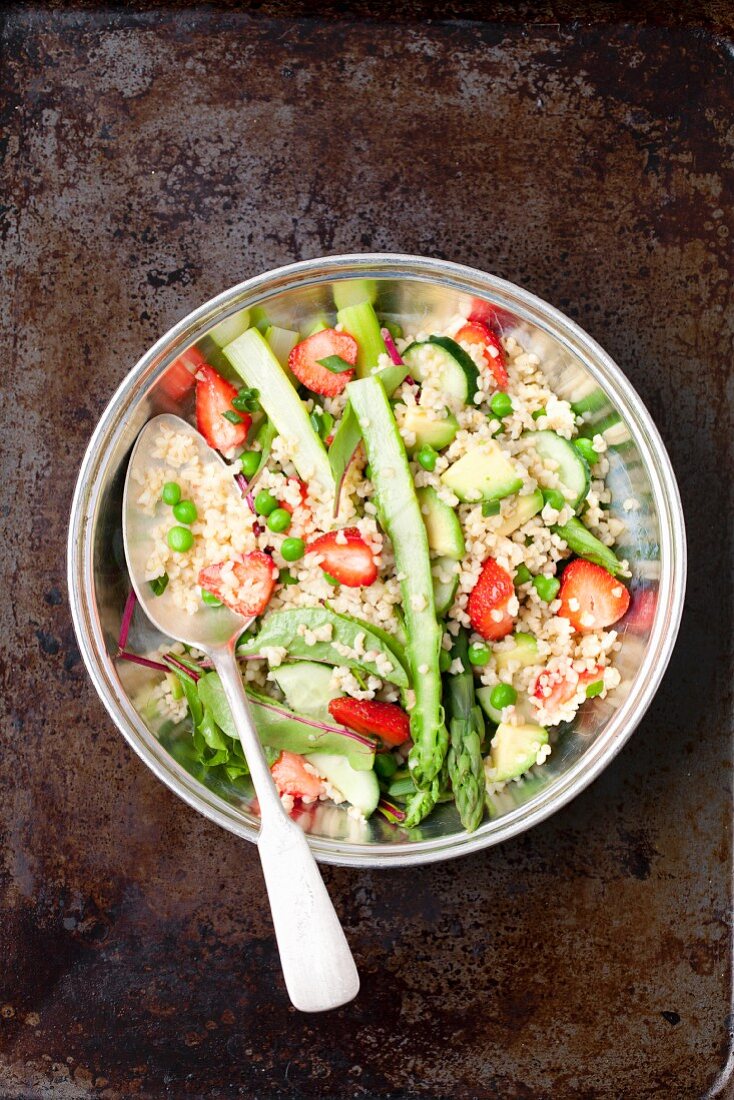 Bulgur and asparagus salad with strawberries, peas and young beetroot leaves