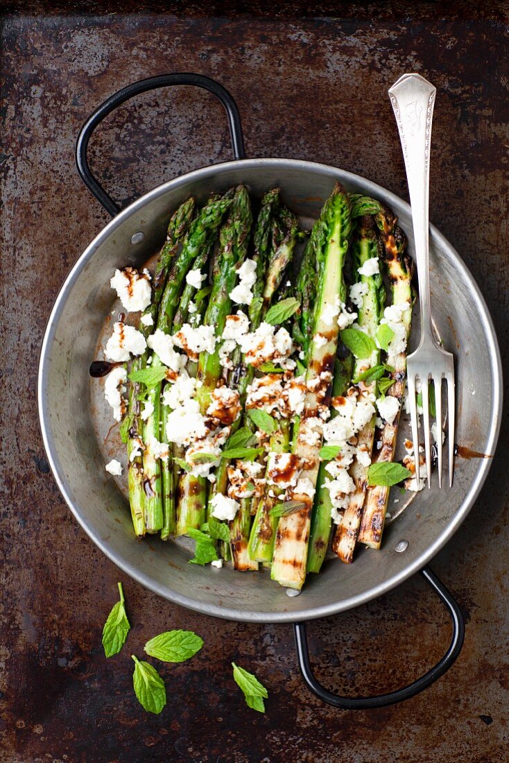 Grilled green asparagus with feta cheese and balsamic vinegar