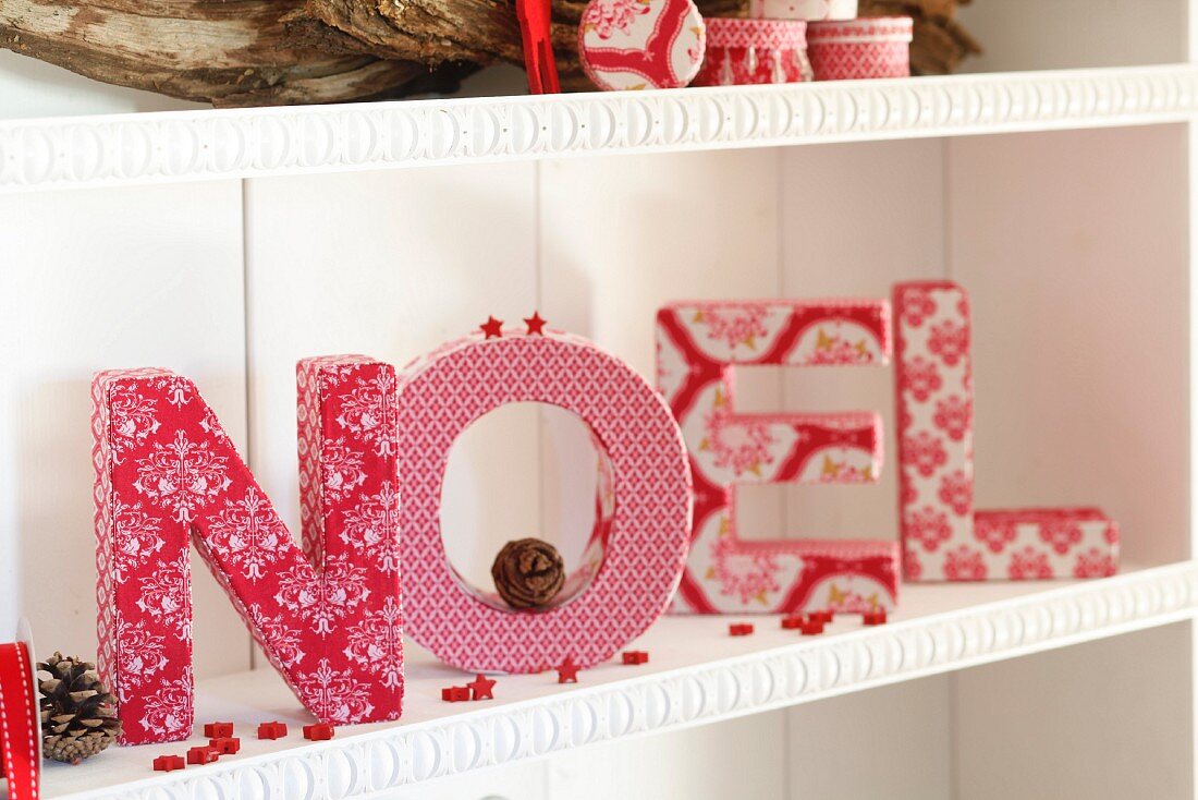 Christmas arrangement of cardboard letters covered in fabric scraps