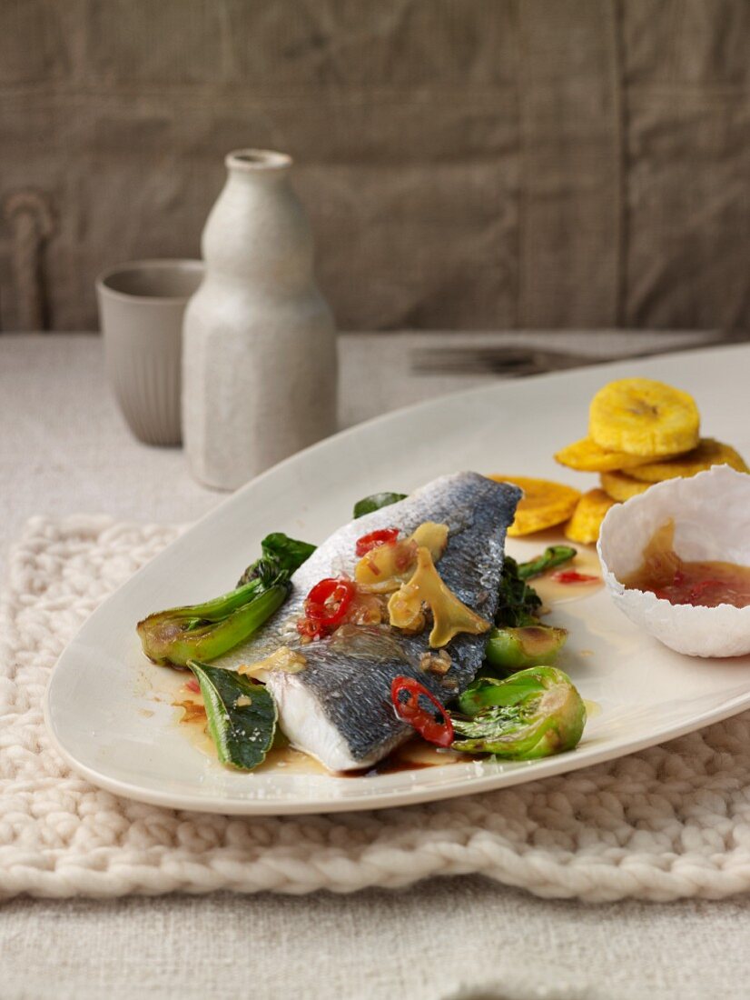 Seabream fillet with a chilli and ginger vinaigrette, bok choy and baked plantains